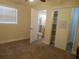 Bedroom with a closet, large window and doorway to bathroom at 1372 S Hillcrest Ave, Clearwater, FL 33756