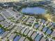 Community overhead view of the houses and surrounding landscape with a pond at 14005 Kingfisher Glen Dr, Lithia, FL 33547