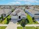 Aerial view of a single Gathering home in a neighborhood with mature trees and lush green lawns at 14005 Kingfisher Glen Dr, Lithia, FL 33547