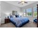 Well-lit bedroom with tray ceiling, fan, carpeted floor, and dual windows with views to the outside at 14005 Kingfisher Glen Dr, Lithia, FL 33547