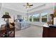 Primary bedroom featuring tray ceilings, carpeted floors and bright, natural light at 14005 Kingfisher Glen Dr, Lithia, FL 33547