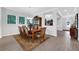 Formal dining room showcasing a wooden table with seating for eight and views of the entryway at 14005 Kingfisher Glen Dr, Lithia, FL 33547