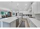 Open-concept kitchen with stainless steel appliances, a large island and bright white cabinetry at 14005 Kingfisher Glen Dr, Lithia, FL 33547