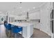 Modern kitchen featuring white cabinets, a large island with bar seating, and stainless steel appliances at 14005 Kingfisher Glen Dr, Lithia, FL 33547