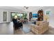 Bright and airy living room with a ceiling fan, a TV and sliding glass doors to the patio at 14005 Kingfisher Glen Dr, Lithia, FL 33547