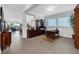 Spacious home office filled with wood furniture, neutral walls and ample natural light at 14005 Kingfisher Glen Dr, Lithia, FL 33547