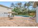 A backyard with a pool, mature trees, and outdoor seating at 14803 Tulip Dr, Tampa, FL 33613