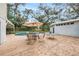 Outdoor patio with seating and dining areas centered around a beautiful in-ground pool at 14803 Tulip Dr, Tampa, FL 33613