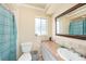 Well-lit bathroom with long countertop and tiled backsplash at 14803 Tulip Dr, Tampa, FL 33613