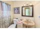 Charming bathroom featuring a pedestal sink and neutral color palette at 14803 Tulip Dr, Tampa, FL 33613