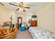 Modest bedroom featuring a ceiling fan and natural light from the window at 14803 Tulip Dr, Tampa, FL 33613