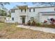 Charming two-story home with grey siding, brick accents, balcony, and a well-manicured lawn at 14803 Tulip Dr, Tampa, FL 33613