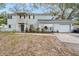 Charming two-story home with grey siding, brick accents, balcony, and a well-manicured lawn at 14803 Tulip Dr, Tampa, FL 33613