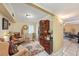 Cozy living room with tile floors, comfortable seating, and a decorative cabinet for storage at 14803 Tulip Dr, Tampa, FL 33613