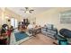 Living room featuring carpet floors, lots of belongings, a ceiling fan, and access to the outside at 14803 Tulip Dr, Tampa, FL 33613