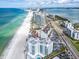 Expansive aerial view of high-rise beachfront condos with pristine beach and vibrant coastal neighborhood at 1590 Gulf Blvd # 501, Clearwater Beach, FL 33767