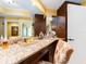 Bathroom vanity featuring granite countertops and dark wood cabinets at 1590 Gulf Blvd # 501, Clearwater Beach, FL 33767