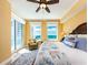 Bright bedroom featuring a plush chair, ceiling fan, and windows with ocean views at 1590 Gulf Blvd # 501, Clearwater Beach, FL 33767