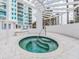 The relaxing hot tub offers a cozy retreat with views of the pool and building at 1590 Gulf Blvd # 501, Clearwater Beach, FL 33767