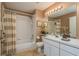 Bathroom featuring a shower-tub combination, neutral walls, and an elegant single-sink vanity at 1788 Biarritz Cir, Tarpon Springs, FL 34689