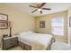 Cozy bedroom with a ceiling fan, window, and neutral color scheme at 1788 Biarritz Cir, Tarpon Springs, FL 34689