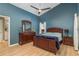 Comfortable bedroom with beautiful wood furniture, a ceiling fan, and ample natural light at 1788 Biarritz Cir, Tarpon Springs, FL 34689