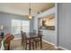 Open dining area with modern lighting and a pass-through view to the kitchen at 1788 Biarritz Cir, Tarpon Springs, FL 34689