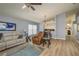 Inviting living room featuring wood-look flooring, a ceiling fan, and ample natural light at 1788 Biarritz Cir, Tarpon Springs, FL 34689