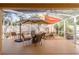 Screened-in patio with comfortable seating, shade sails, and a decorative water feature at 1788 Biarritz Cir, Tarpon Springs, FL 34689