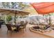 Relaxing screened-in patio area featuring shade sails, comfortable seating, and a decorative water feature at 1788 Biarritz Cir, Tarpon Springs, FL 34689