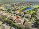 Aerial view of a home in a well-planned community featuring mature trees and waterfront views at 1912 Acadia Greens Dr, Sun City Center, FL 33573