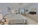 Bright and spacious bedroom with neutral carpet and furnishings, including a leather armchair by the window at 1912 Acadia Greens Dr, Sun City Center, FL 33573