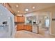 Well-lit kitchen featuring wood cabinets, granite countertops, and modern white appliances at 1912 Acadia Greens Dr, Sun City Center, FL 33573