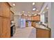 Spacious kitchen featuring wood cabinets, granite countertops, modern appliances, and a wine cooler at 1912 Acadia Greens Dr, Sun City Center, FL 33573