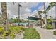 Relaxing community pool area with lounge chairs, umbrellas, and lush landscaping, ideal for leisure at 1912 Acadia Greens Dr, Sun City Center, FL 33573