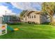 View of backyard featuring a green yard, trampoline, slide, and seating area at 1924 W Carmen St, Tampa, FL 33606