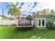 Backyard featuring a trampoline, storage shed, artificial lawn, and white fence at 1924 W Carmen St, Tampa, FL 33606