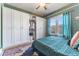 Bedroom with closet and window with curtains allowing in natural light at 1924 W Carmen St, Tampa, FL 33606