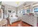 Cozy bedroom with hardwood floors, dresser, and natural lighting from windows at 1924 W Carmen St, Tampa, FL 33606