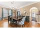 Spacious dining room with hardwood floors, chandelier lighting, and an archway entrance to the hallway at 1924 W Carmen St, Tampa, FL 33606