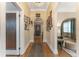 Hallway with hardwood floors, archway entrance to rooms, and decorative artwork on the walls at 1924 W Carmen St, Tampa, FL 33606