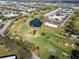 This aerial view showcases a lush golf course community with a heart-shaped pond and well-maintained greens at 2293 Swedish Dr # 37, Clearwater, FL 33763