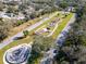 This aerial view captures a parkway with decorative arches, lush landscaping, and pedestrian-friendly walkways for community enjoyment at 2293 Swedish Dr # 37, Clearwater, FL 33763