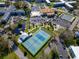 A captivating aerial view showcases tennis and pickleball courts, a pond, and recreational area surrounded by lush landscaping at 2293 Swedish Dr # 37, Clearwater, FL 33763