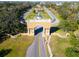 Aerial view of community entrance featuring decorative architecture and a large landscaped median at 2293 Swedish Dr # 37, Clearwater, FL 33763