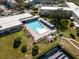 Aerial view of community pool and clubhouse with lounge chairs and solar panels at 2293 Swedish Dr # 37, Clearwater, FL 33763