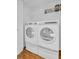 White stacked washer and dryer with storage shelf at 2293 Swedish Dr # 37, Clearwater, FL 33763