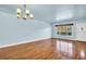 Bright living room with wood floors, a large window, and modern chandelier at 2293 Swedish Dr # 37, Clearwater, FL 33763