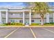 Exterior shot of condo building featuring balconies, lush landscaping, and ample parking at 2298 Americus E Blvd # 6, Clearwater, FL 33763