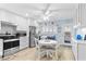 Well-lit kitchen with white cabinetry, stainless steel appliances, and cozy dining space at 2298 Americus E Blvd # 6, Clearwater, FL 33763